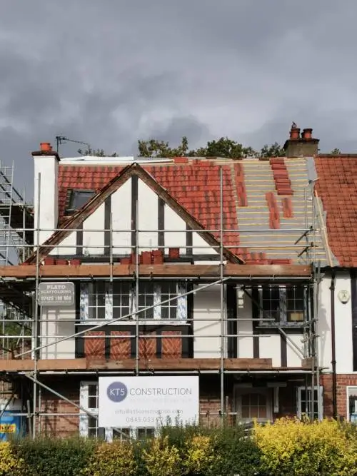 body-img-temp-1 Pitched roof repair in Guildford featuring new slate tiles.