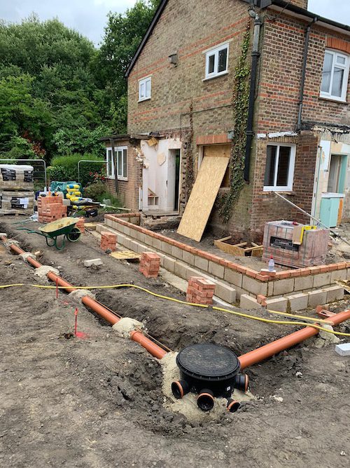  Drainage contractors installing a custom system in Surrey.