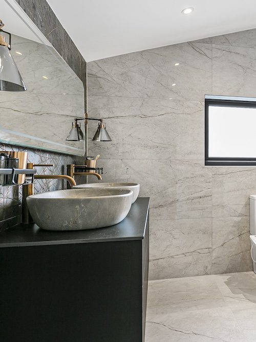 Elegant ensuite bathroom in a Surrey attic conversion with marble finishes.