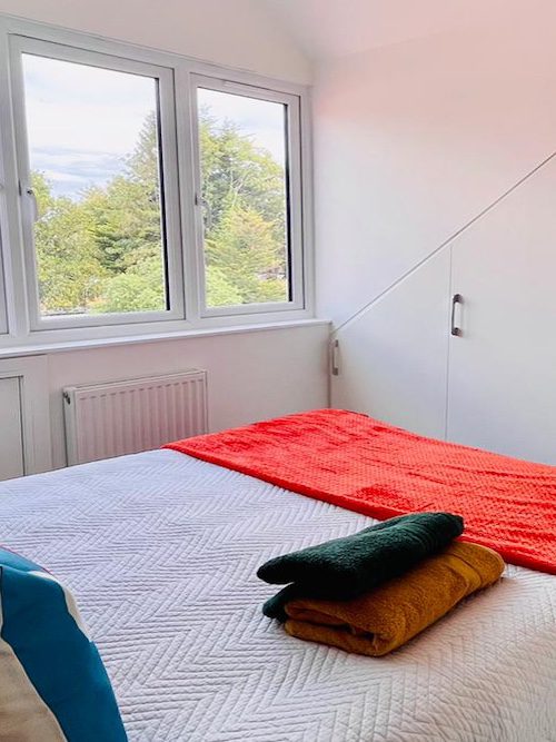 Bright and cozy children’s bedroom in a Surrey attic conversion with built-in storage.