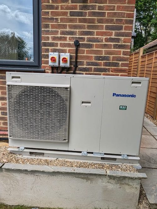 Air Source Heat Pump Installer setting up a new unit